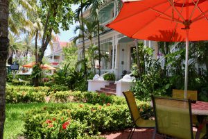 Southernmost Point Guesthouse Courtyard with bright orange umbrella